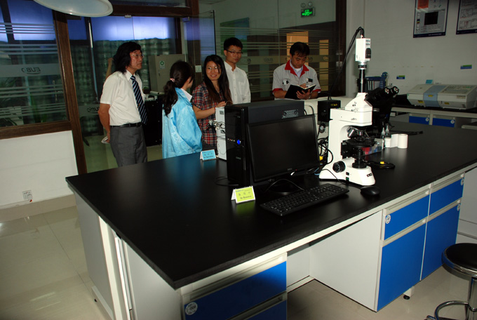 日本代表聆听优宝实验室同事对实验仪器的介绍并做笔录